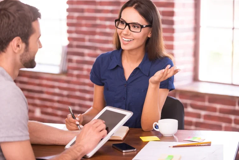 Business professionals discussing strategy in meeting — KORE1 staffing and recruiting solutions for technology and engineering companies