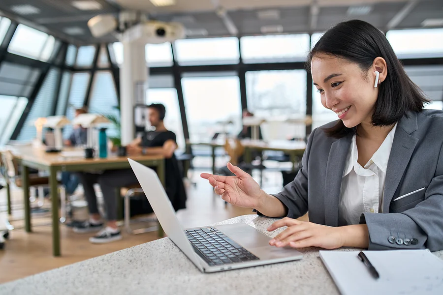 Young Asian businesswoman employee working at desk — KORE1 IT staffing agency placing diverse technology talent at top companies