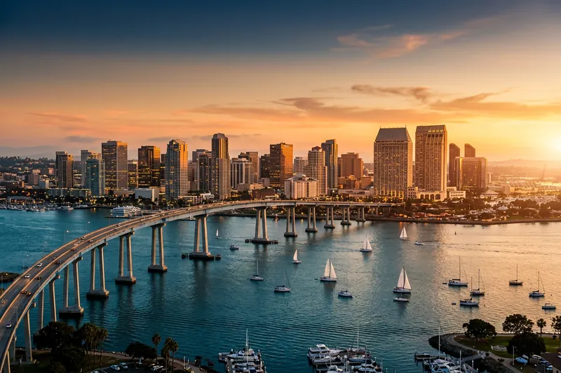 San Diego skyline at golden hour with Coronado bridge visible, representing the local KORE1 fractional CFO bench