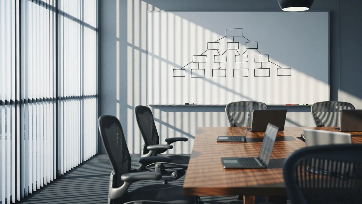 Empty glass-walled conference room with a partial hierarchical org chart drawn on the whiteboard, representing the AI hiring gap