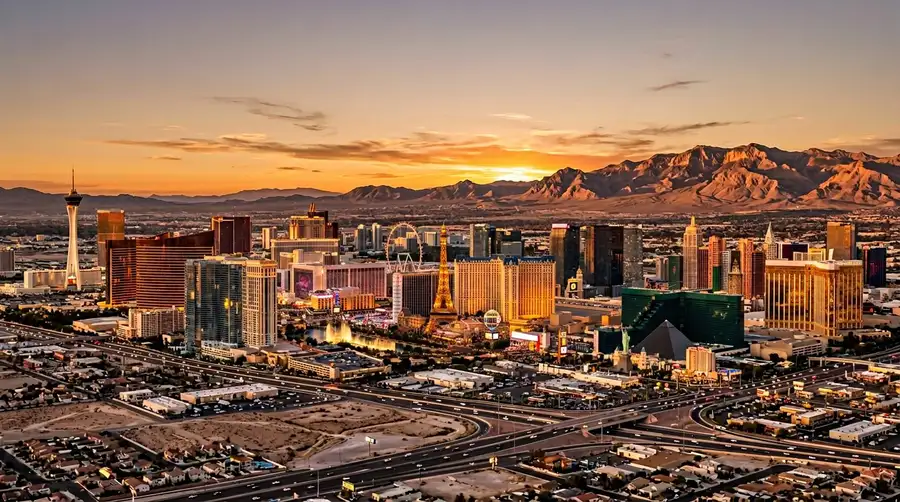 Las Vegas skyline at golden hour with surrounding desert landscape