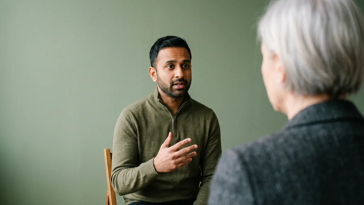Product marketing manager candidate answering an interview question, seen over the shoulder of the hiring manager
